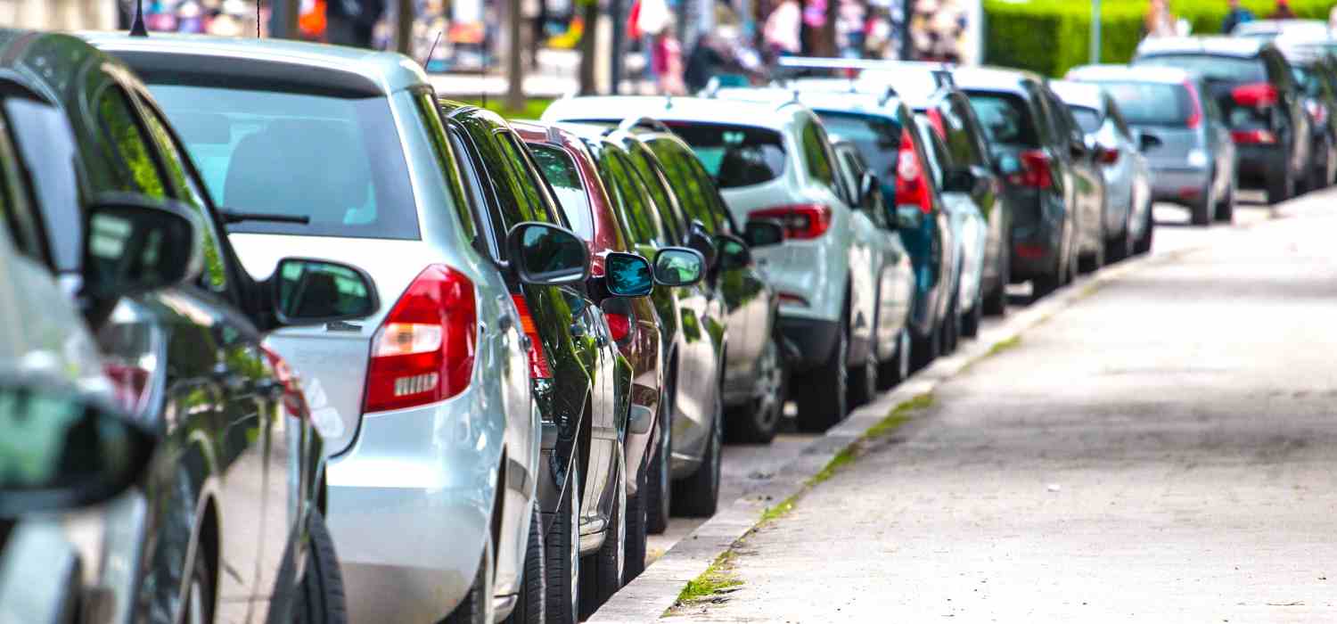 Parking of cars near the sidewalk for pedestrians, the cars stand in row on Parking in the old town.